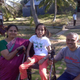 Nidhi Shirol on a wheelchair with her parents on either side in a park